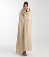 Woman wrapped in EMF protective blanket for travel by Leblok
