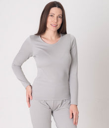  A woman wearing a long-sleeved grey EMF protective vest and matching leggings from Leblok