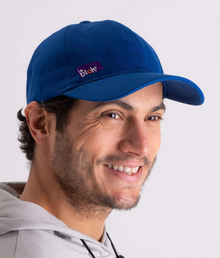  A person wearing a royal blue EMF protective cap Leblok