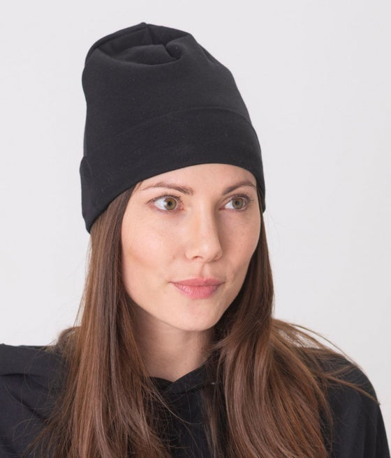 EMF protective beanie Leblok in black displayed on a woman - with matching Leblok hoodie