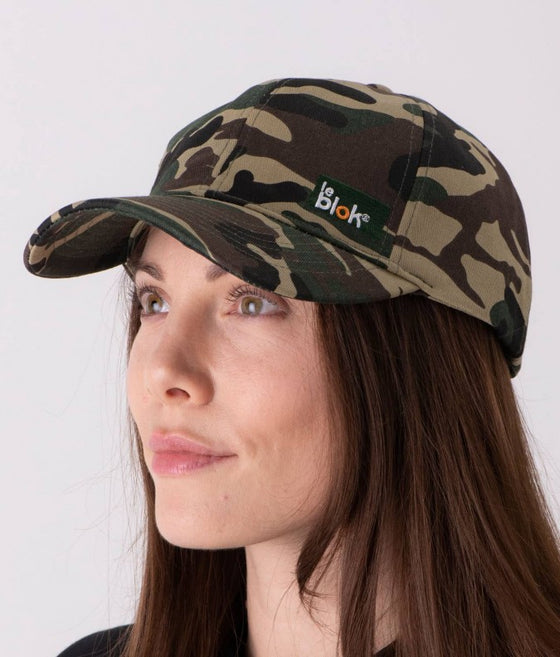 A woman wearing a camouflage EMF protective cap Leblok