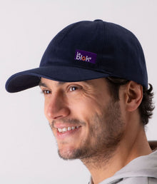  A person wearing a navy blue EMF protective cap Leblok