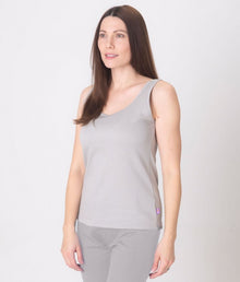  A woman wearing a gray EMF protective vest and matching EMF protective leggings Leblok