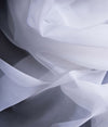 A close-up of white semi-transparent EMF reflective fabric Veil